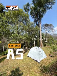 a tent sitting in the grass next to a sign at The Hunting Rat Campsite in Ban Tai +79 photos