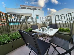 a patio with a table and chairs on a balcony at Nido Salento Gallipoli in Gallipoli