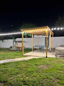 a pavilion with a picnic table in a park at night at ARThouse Garni in Garni +18 photos
