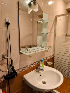 a bathroom with a sink and a mirror at TihON Studio in Byala