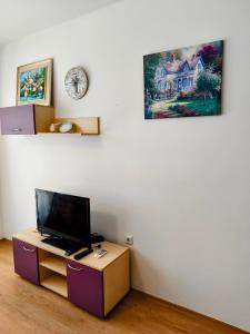 a room with a desk with a tv on a wall at TihON Studio in Byala
