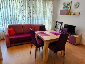 a living room with a table and a couch at TihON Studio in Byala +5 photos
