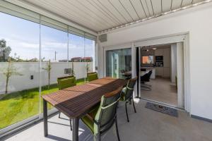 a dining room with a table and chairs on a balcony at Alba Family Home in Zadar