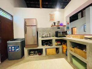 a kitchen with a refrigerator and a counter at Marisol Villa in Unawatuna +21 photos