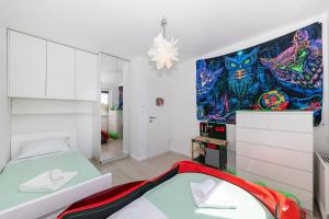 a bedroom with a bed and a painting on the wall at Alba Family Home in Zadar +35 photos