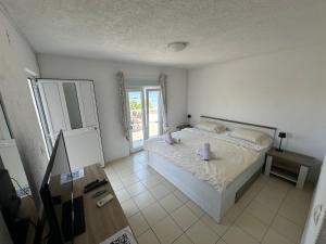 a bedroom with a bed with two pillows on it at Apartments Kovač in Vir