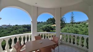 a room with a balcony with a table and chairs at Sunflower Apartments & Studios in Laganas