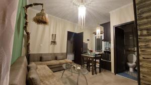 a living room with a couch and a table at The Mastiha Spot 1 in Chios