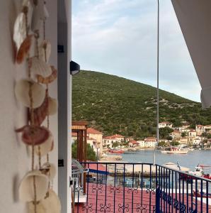 a view from a balcony with a view of the water at Anemologio Fine Village Living in Ayía Kiriakí