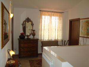 a living room with a dresser and a mirror at La Sosta di Braccio in Macchie +35 photos