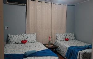 a bedroom with two beds with red hearts on them at Pousada Pôr do sol in Belém