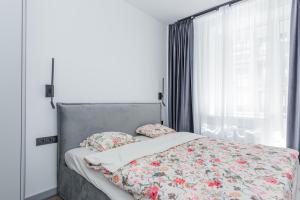 Ένα ή περισσότερα κρεβάτια σε δωμάτιο στο D21 Apartamentai