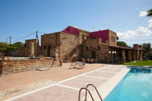 a house with a swimming pool in front of it at Kampos Mansion 1 in Chios