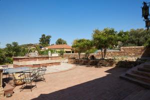 a patio with a table and chairs on a brick patio at Kampos Mansion 1 in Chios