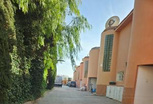 a street with a building with a clock on it at L'oasis d'Agadir - Agadir's hidden Oasis in Agadir