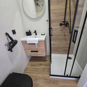 a bathroom with a sink and a shower with a mirror at Sun Anna Apartments in Pag +38 photos