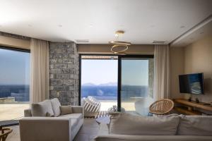 A seating area at Seafront elegant villas, with infinity pools & devine views!