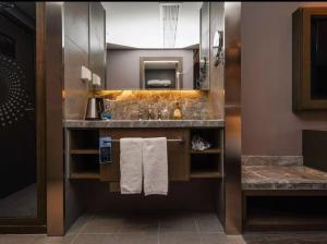 a hotel bathroom with a sink and towels at Crystal Orange Shanghai Lingang Ocean Park Hotel in Nianbalian +24 photos