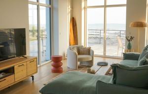 a living room with a view of the ocean at Loft vue mer - Angoulins - Villa Oasis in Angoulins-sur-Mer