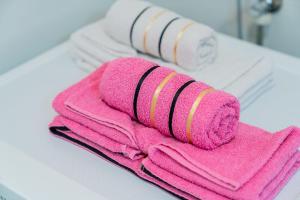 a pile of pink towels sitting on top of a counter at Flex SelfCheckIns 149 - Zagreb - Bedroom - Garage - Loggia in Zagreb