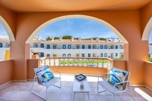 a balcony with two chairs and a table and a building at Casa Sunrise in Lagos