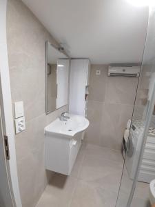 a white bathroom with a sink and a shower at Villa Romantica in Blato +12 photos
