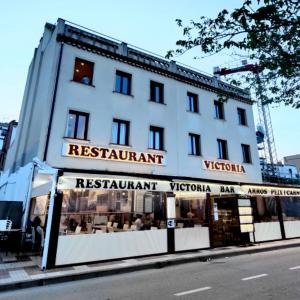 a white building with a restaurant in front of it at LETS HOLIDAYS Centric & Near the Sea Victoria apartment 3 in Tossa de Mar