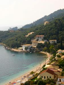 a beach with a group of people on the beach at Lena Blue Sea Apartments in Kalami