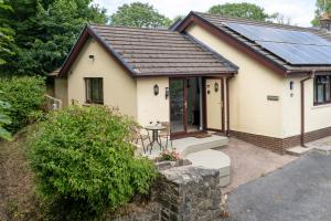 a house with solar panels on the roof at The Willows - Peaceful Retreat in Saundersfoot