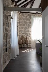 a room with white curtains and a brick wall at Heritage house Stone Orchard, near Dubrovnik in Orasac +86 photos