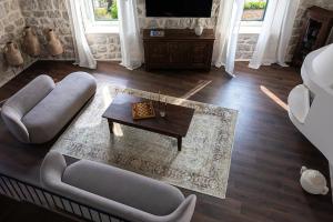 a living room with a couch and a coffee table at Heritage house Stone Orchard, near Dubrovnik in Orasac