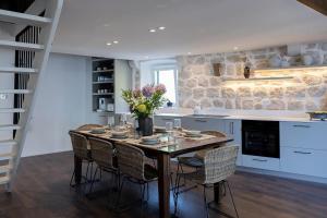 a kitchen with a table with chairs and a counter at Heritage house Stone Orchard, near Dubrovnik in Orasac