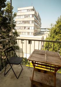 a chair and a table on a balcony with a building at Apartment Residenz in Klagenfurt
