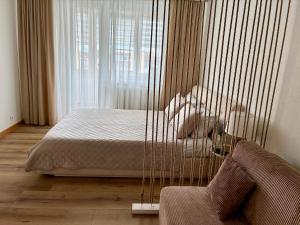 a bedroom with a bed in a cage at Liepų Apartamentai in Molėtai