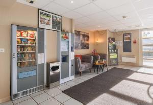 a waiting area in a hospital with vending machines at B&B HOTEL Aurillac Le Lioran in Aurillac