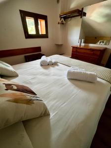 a bedroom with two beds with towels on them at Casa dello Sciatore Lorica in Lorica
