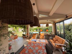 a patio with a couch and a table at La Bastide des Romarins in Plan-dʼOrgon