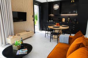 a living room with a couch and a table at Apartamenty Złote Tarasy in Brodnica Dolna