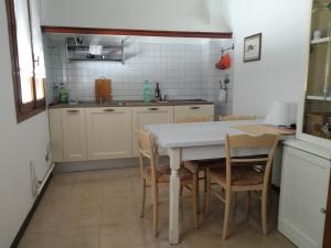 a kitchen with a white table and chairs at La Terrazza in Tarzo