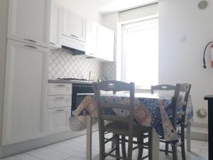 a kitchen with a table with chairs and a stove at Casa Regina Elena II in Termoli