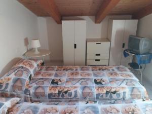 a bedroom with a bed and a tv at Casa Regina Elena II in Termoli