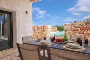 a table with a plate of fruit and a bottle of wine at TD Trullo Diamante – Pure Relaxation Privacy in Putignano