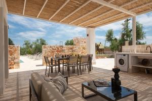 a patio with a couch and a table with chairs at TD Trullo Diamante – Pure Relaxation Privacy in Putignano +23 photos