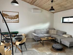 a living room with a couch and a table at Luxusný Apartman s velkou terasou in Telgárt +21 photos