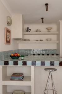 a kitchen with a counter with a bowl of fruit at Spacious, seaside pied-à-terre with stunning views, opposite Cott beach & cafes in Perth