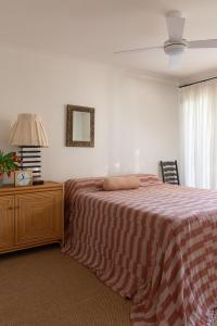 a bedroom with a bed and a table with a lamp at Spacious, seaside pied-à-terre with stunning views, opposite Cott beach & cafes in Perth +11 photos
