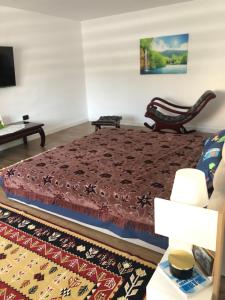 a bedroom with a bed and a couch at Ulita in Bumbeşti-Jiu