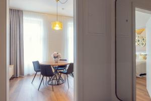 a room with a table and chairs and a bedroom at LeonArt Living 34 in Graz