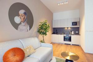 a living room with a couch and a painting on the wall at LeonArt Living 34 in Graz