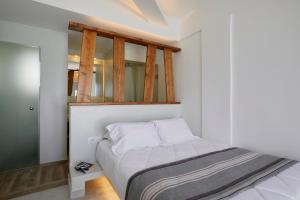 a bedroom with a bed with a mirror above it at Santorini View in Akrotiri